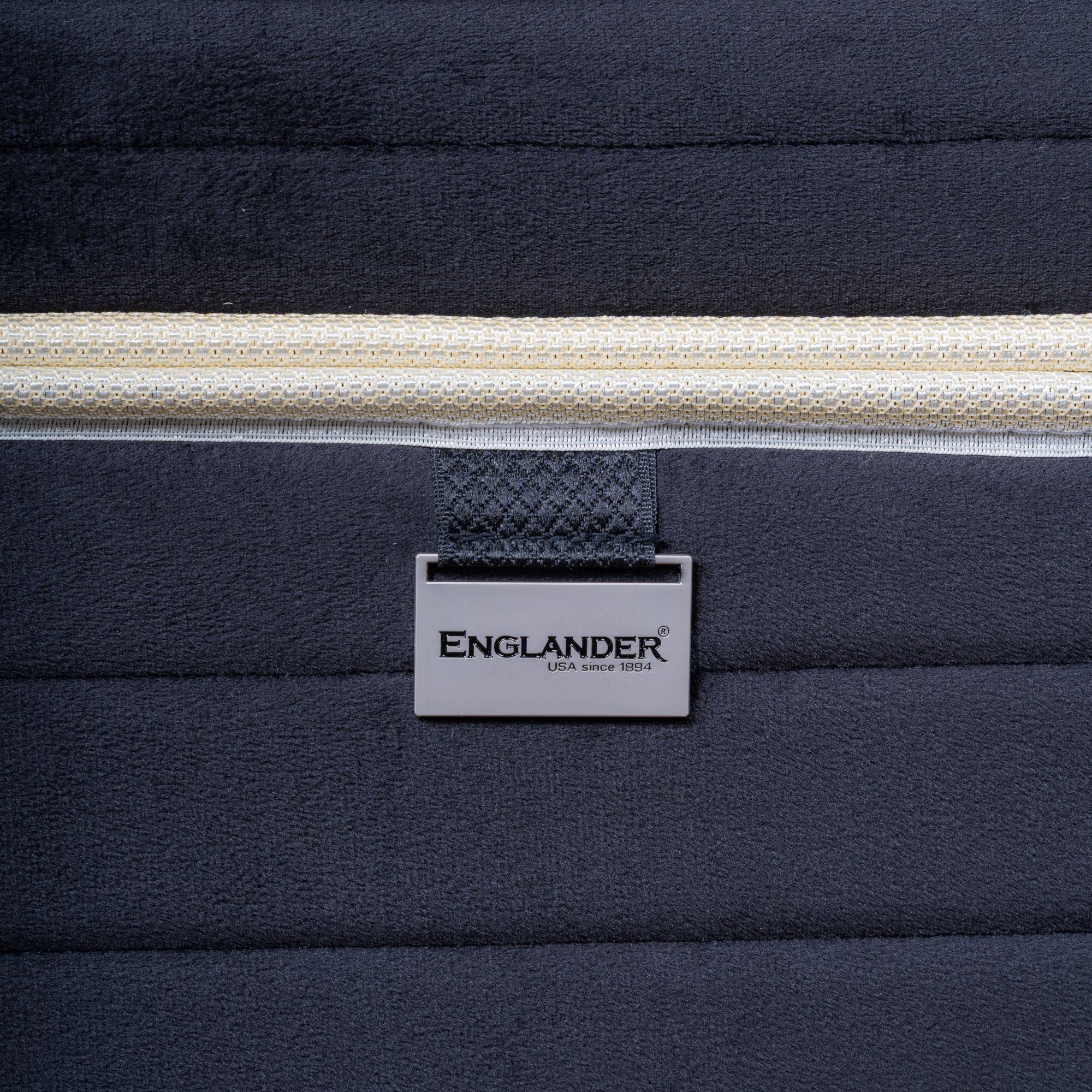 Navy blue mattress showing 'Englander' brand logo.