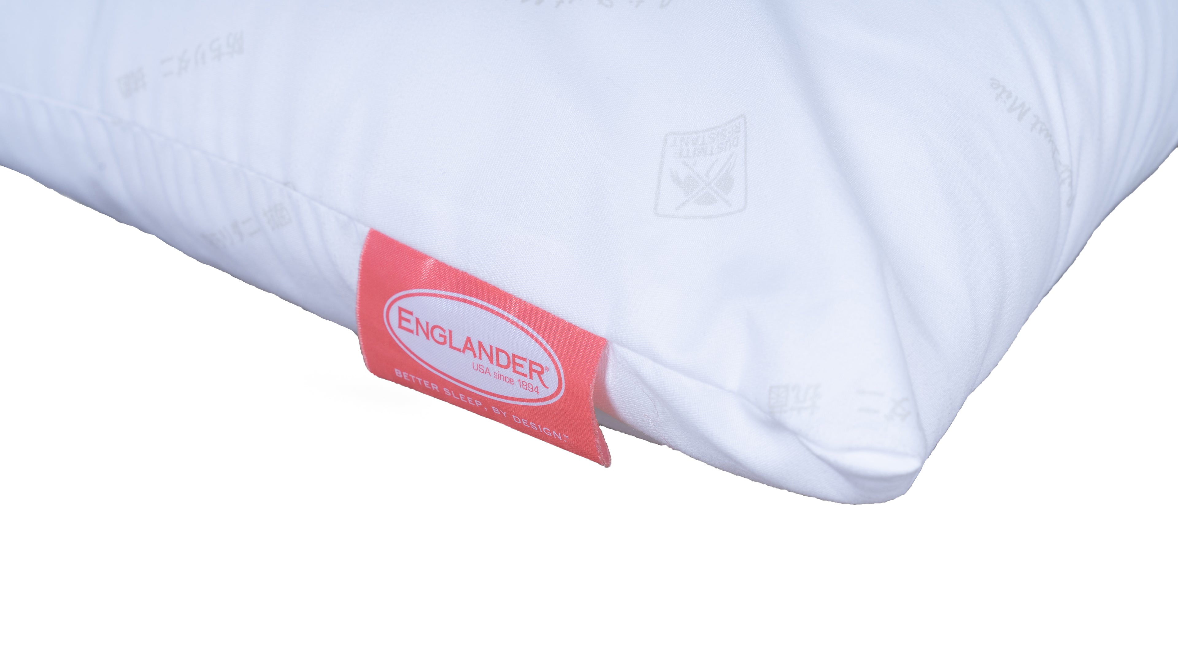 A close-up of a white Soft pillow with a red fabric tag on the side. The tag has a white oval label with the brand name 'ENGLANDER' printed in red.