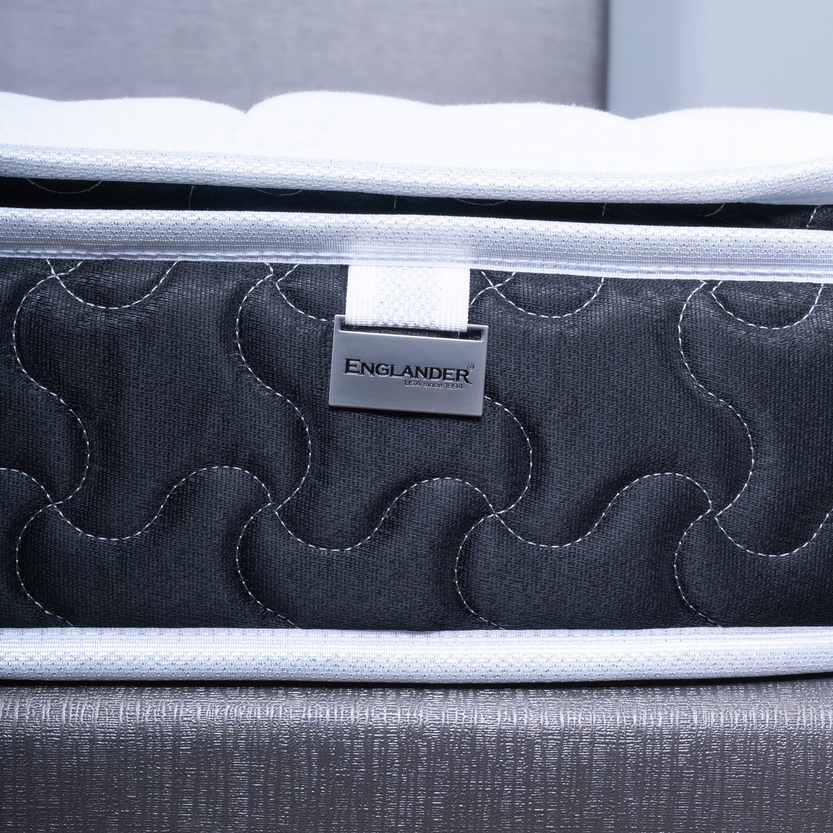 Englanders Spinal Care Mattress with 'Englander' brand label in metal tag stitched to the side of the mattress