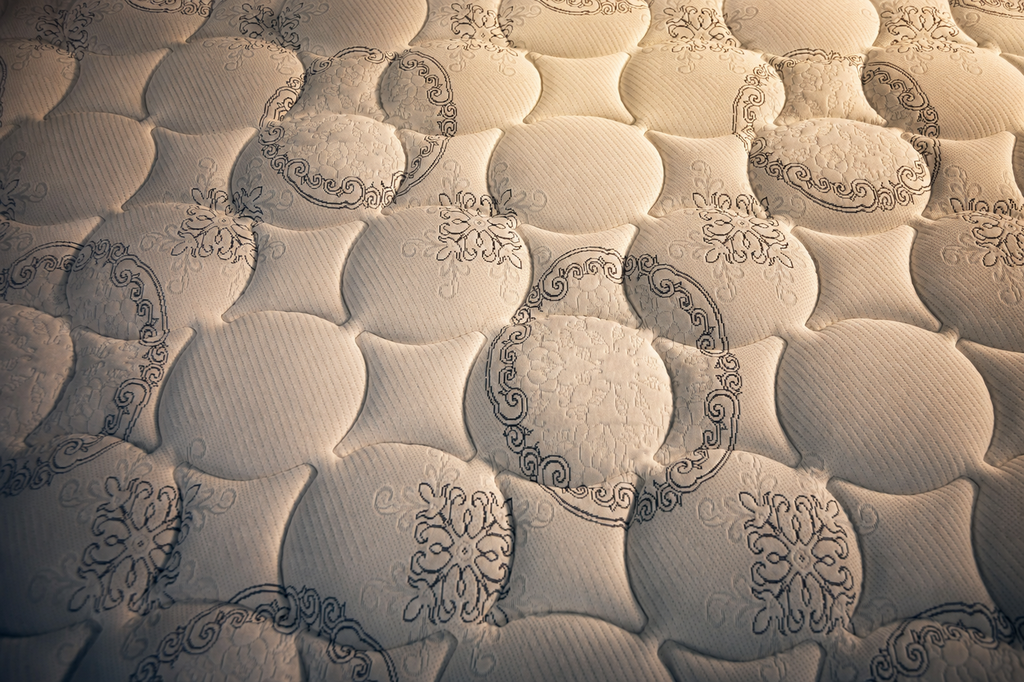 Close-up illustration of quilted Tencel mattress fabric with a circular stitched pattern.