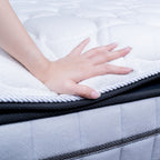 Hand touching a mattress to check its softness